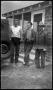 Primary view of [Three Men in Front of a Bunkhouse]