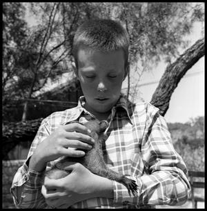 Primary view of object titled '[Ardon Judd with Baby Raccoon]'.