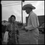 Photograph: [Woman Speaking with a Man]