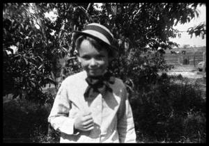 Primary view of object titled '[Boy Standing by a Tree]'.