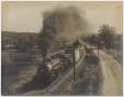 Photograph: [Photograph of a Train Rolling down the Tracks]