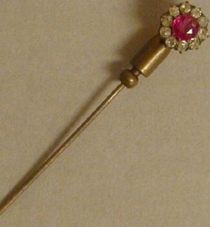 Primary view of object titled '[Tie pin with a ruby in the center, surrounded by ten small diamonds]'.