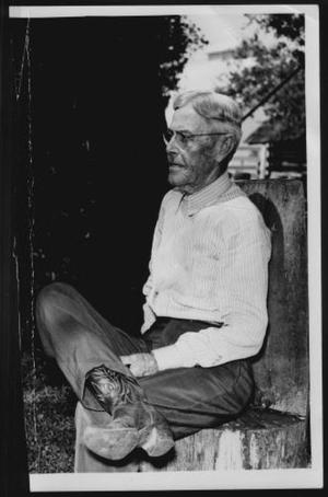 Primary view of object titled '[Albert Peyton George seated on a chair in the George Ranch yard]'.