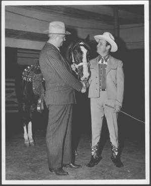 Primary view of object titled '[Mr. Virgil Henry Shepherd and Mr. Gene Autry shaking hands]'.