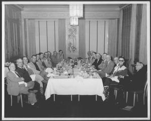 Primary view of object titled '[Albert Peyton George and a group of men in the dining room of a Houston hotel]'.