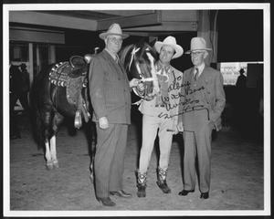 Primary view of object titled '[Albert Peyton George, Gene Autry, and Virgil Shepherd standing next to a horse]'.