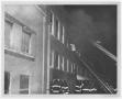 Photograph: [Firefighters and a Smoking Building]
