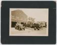 Photograph: [Firefighters and Small Boy on Two Fire Engines]