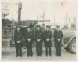 Photograph: [Firefighters Standing in Front of Fire Engine]