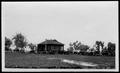 Photograph: [A large group of automobiles parked in front of Camp George]