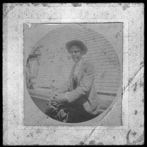 Primary view of object titled '[Albert Peyton George seated on a bench, with his hands clasped together]'.