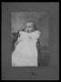 Thumbnail image of item number 1 in: '[An infant sitting in a chair and wearing a white gown with lace insets]'.