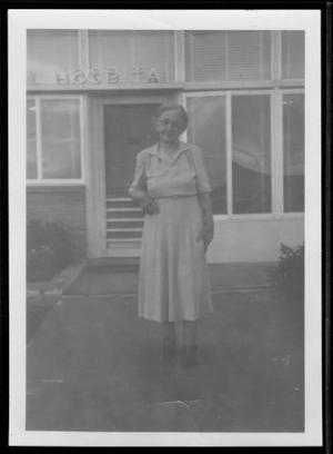 Primary view of object titled '[Photograph of Mamie Davis George standing on the sidewalk]'.