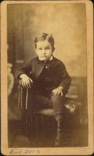 Primary view of object titled '[Bud Davis as a boy, sitting with his right leg tucked under his left leg]'.