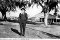 Photograph: [Wiley Jones standing in the middle of two trees]