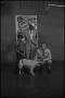 Photograph: [Two Men, Young Boy, and  Dog on Television Stage]