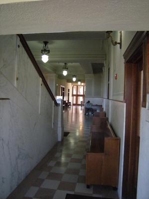 Primary view of object titled '[Benches in a Hallway]'.
