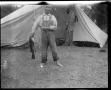 Photograph: [Photograph of Boy with Fish in Front of Tent]