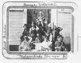 Thumbnail image of item number 1 in: '[Photograph of nine first grade students sitting/standing on the steps of the George School]'.