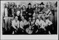 Photograph: [Country band wearing hats and holding various instruments]