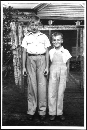 Primary view of object titled '[Albert Lee Linke and Glen Roy Linke standing in front of their home]'.