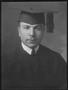 Primary view of [A young man wearing a graduation gown with cap and tassel]