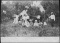 Photograph: [A group of eleven people camped out in a pasture]