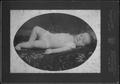 Photograph: [Frances Lee Baker as an infant, reclining on a floral coverlet]