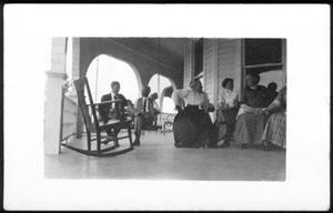 Primary view of object titled '[Postcard image of a group of people gathered on a porch]'.
