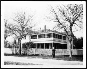 Primary view of [George Ranch house with Mamie George standing in front]