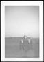 Photograph: [A man on a tractor in a field on the George Ranch]