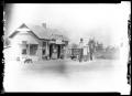Photograph: [Photograph of a Service Station and an Automobile]