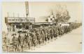 Postcard: [Postcard of Soldiers Marching by the Capitol Theater]